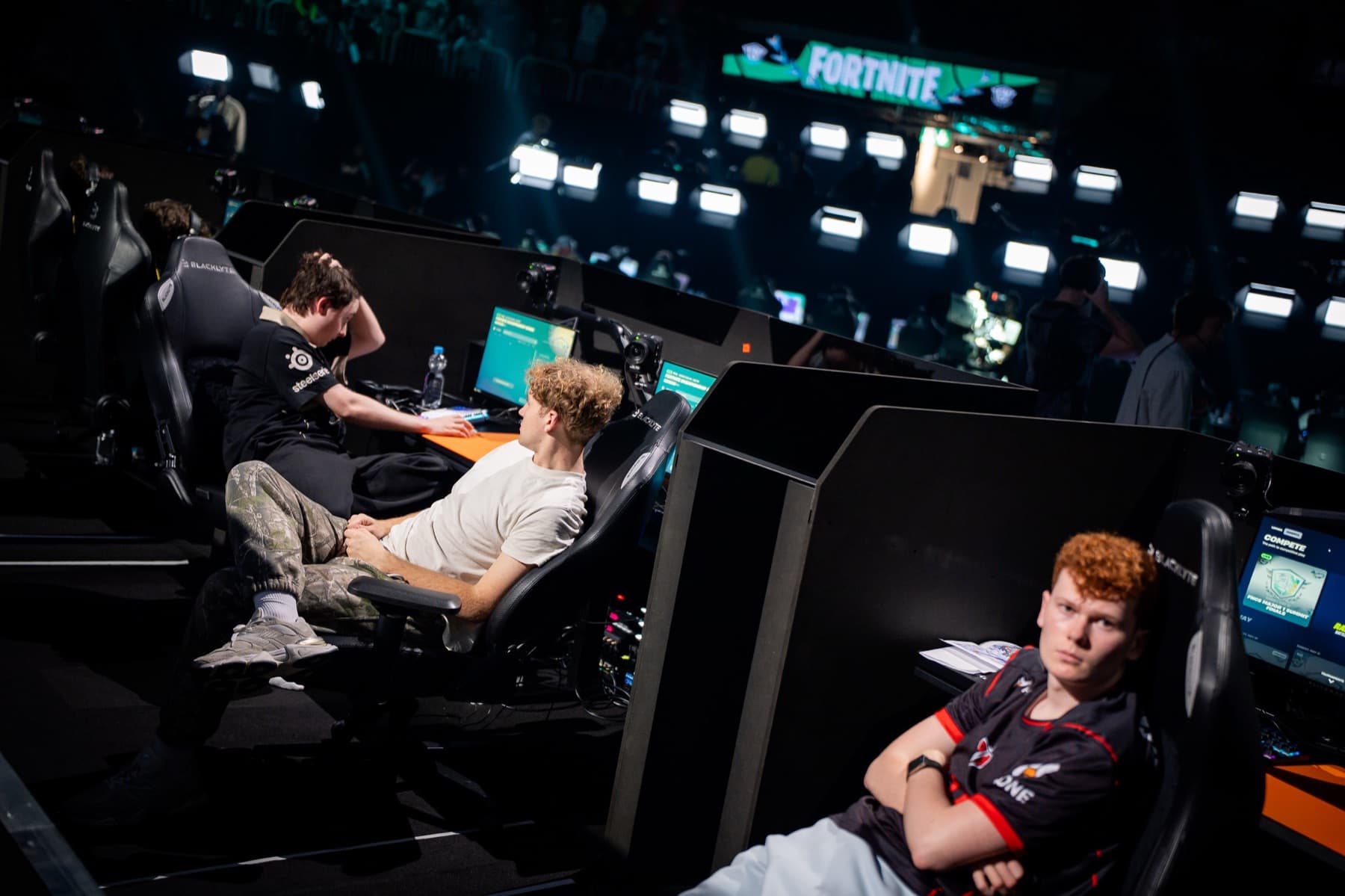 Elite Fortnite players at a tournament station — controller PC optimization with Hone