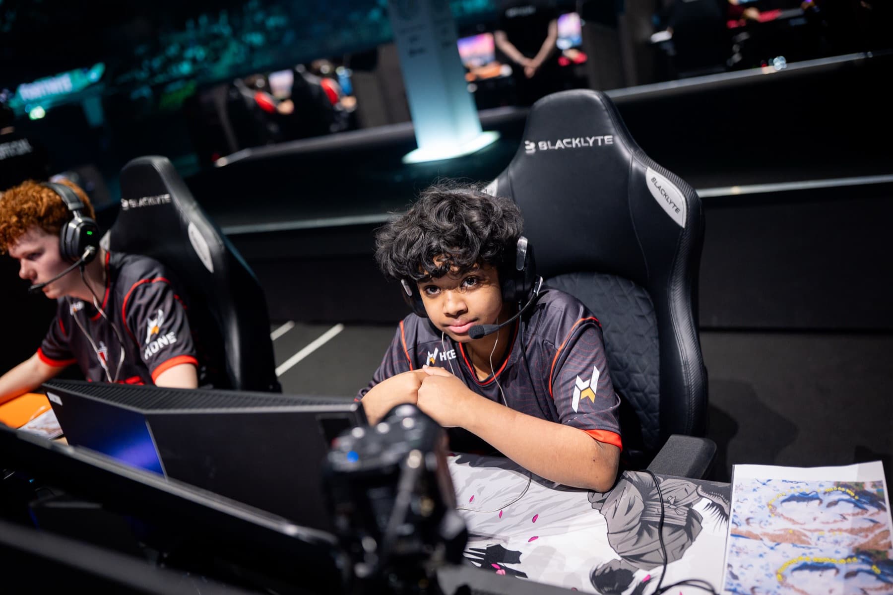 An Elite Fortnite pro at a tournament station running a high-FPS setup