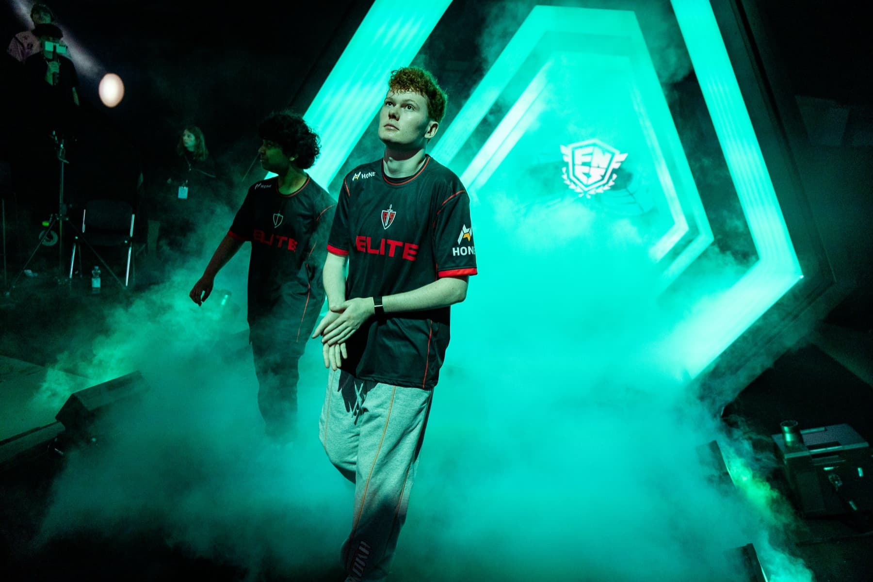 An Elite competitor walking toward an esports stage