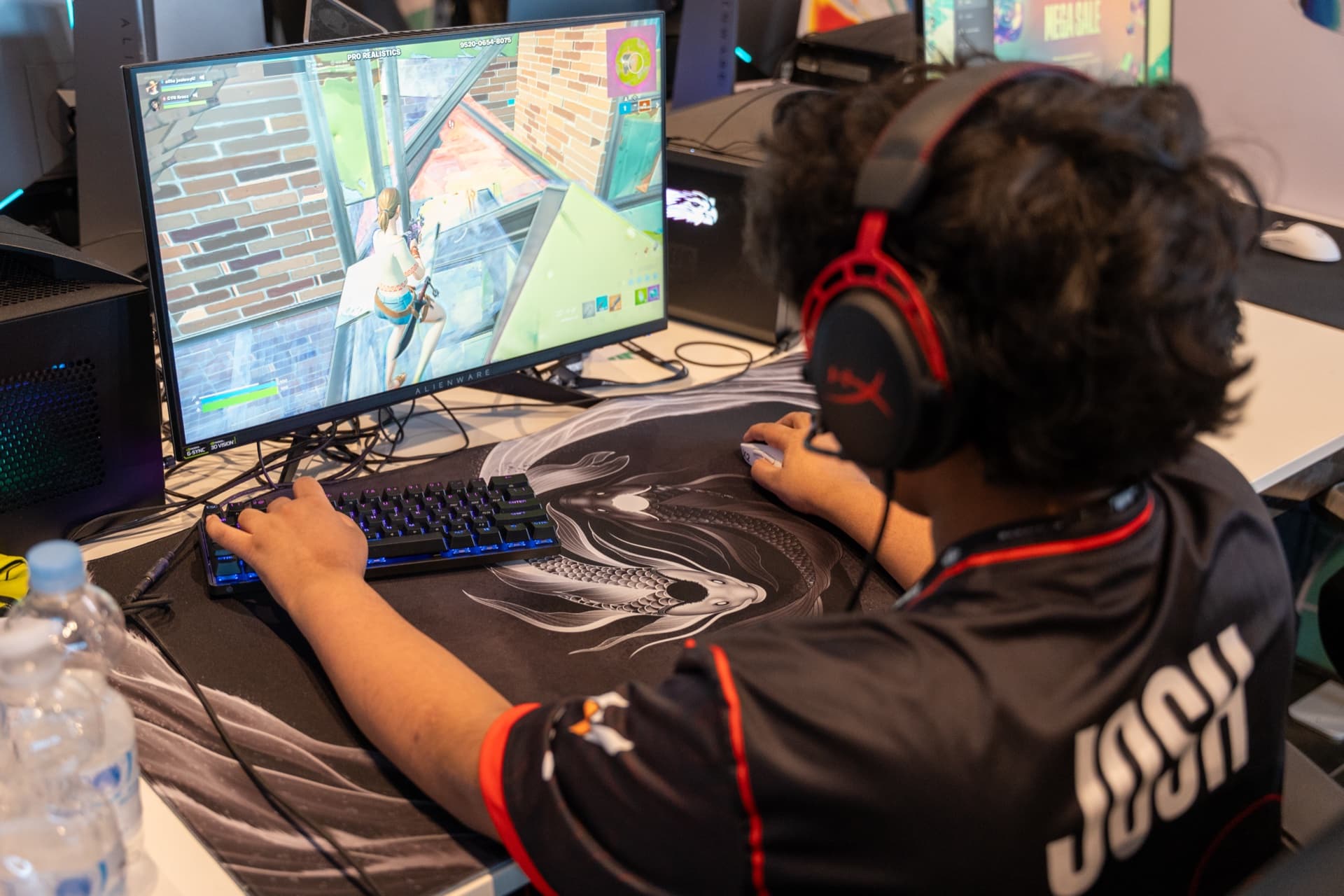 Josh competing at a Fortnite tournament station